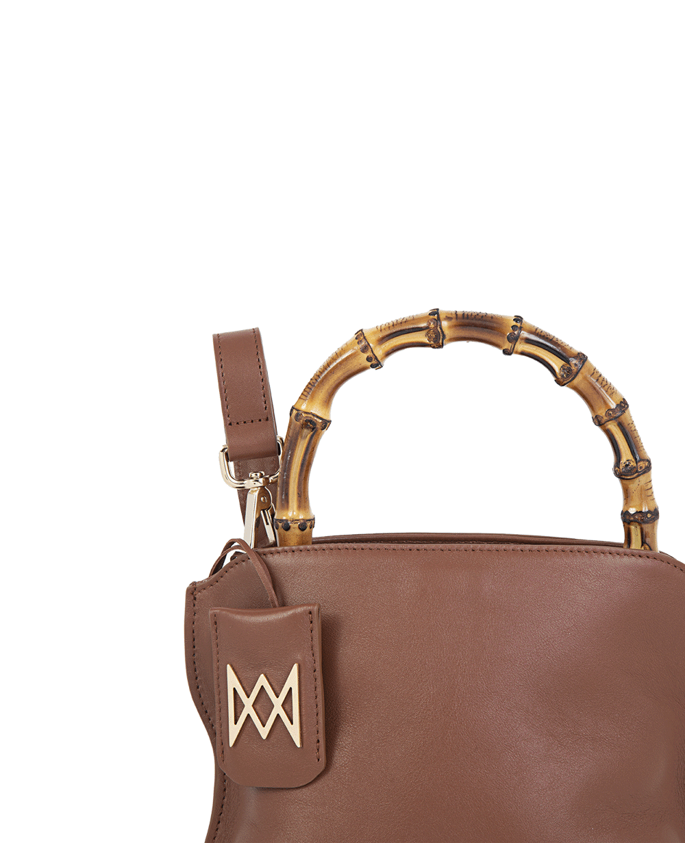 Cross-body bag in calf leather with detachable shoulder strap. Bamboo handles. Made In Italy. Two compartments, zip pocket in the back compartment. Magnetic flap closure with logo. Color: Mocha. Size: Medium 