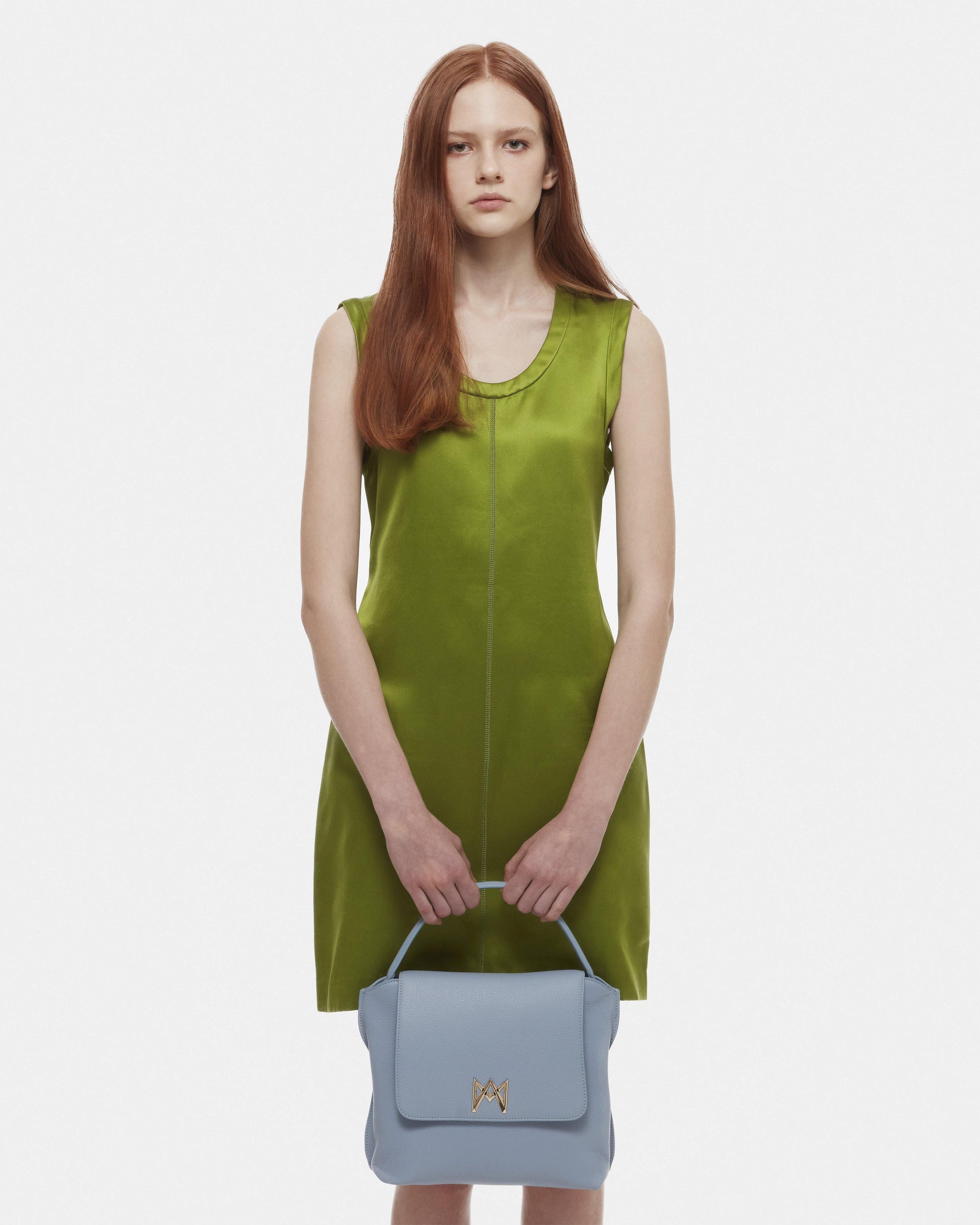 Cross-body bag in Italian full-grain leather, semi-aniline calf Italian leather with detachable shoulder strap.Three compartments, zip pocket in the back compartment. Magnetic flap closure with logo. Color: Baby Blue. Size:Large