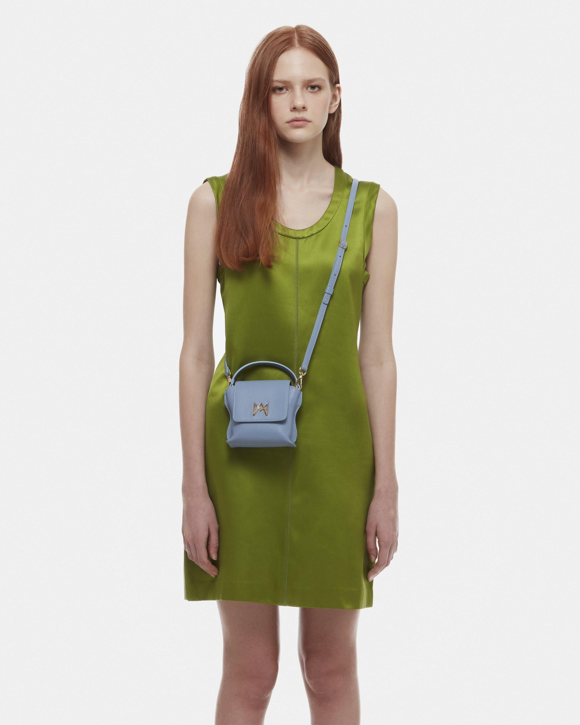 Cross-body bag in Italian full-grain leather, semi-aniline calf Italian leather with detachable shoulder strap.Three compartments, zip pocket in the back compartment. Magnetic flap closure with logo. Color: Baby Blue. Size:Mini