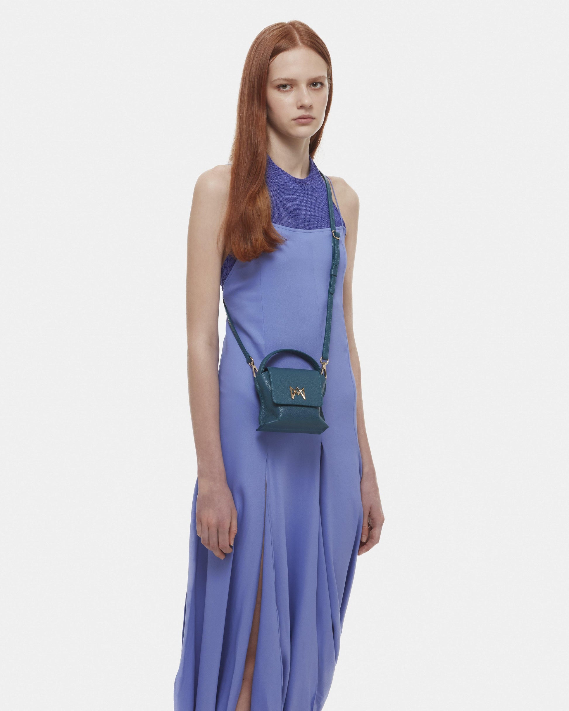 Cross-body bag in Italian full-grain leather, semi-aniline calf Italian leather with detachable shoulder strap.Three compartments, zip pocket in the back compartment. Magnetic flap closure with logo. Color: Teal. Size:Mini