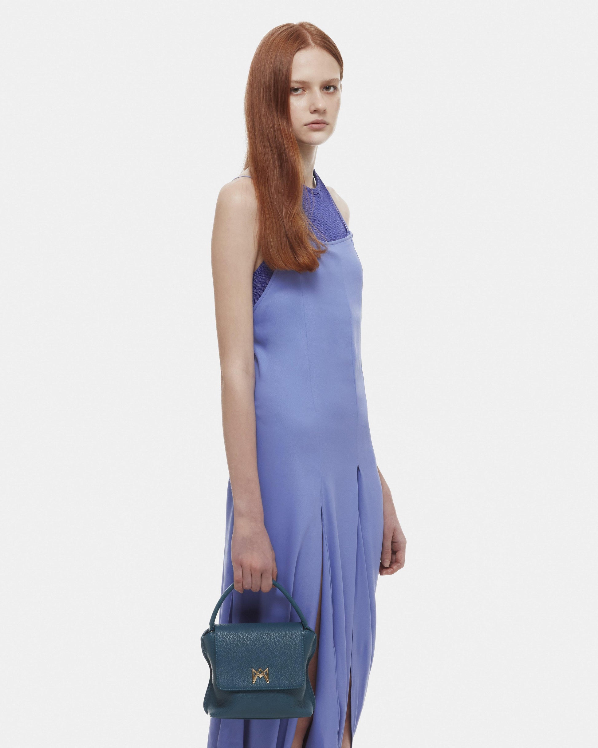 Cross-body bag in Italian full-grain leather, semi-aniline calf Italian leather with detachable shoulder strap.Three compartments, zip pocket in the back compartment. Magnetic flap closure with logo. Color: Teal. Size:Medium