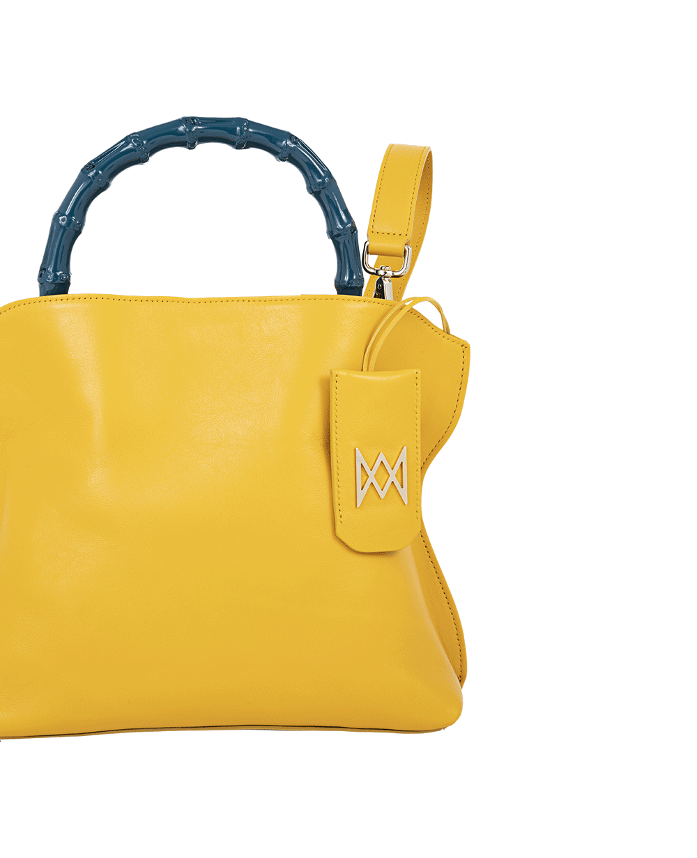 Cross-body bag in calf leather with detachable shoulder strap. Bamboo handles. Made In Italy. Two compartments, zip pocket in the back compartment. Magnetic flap closure with logo. Color: Saffron. Size: Large